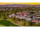 An aerial shot showing homes in the community, with a golf course and cityscape in the distance at 3665 S Jojoba Way, Chandler, AZ 85248