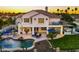 An aerial shot of a backyard with a pool, outdoor seating, a fire pit, and landscaped gardens at 3665 S Jojoba Way, Chandler, AZ 85248