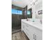 Bathroom with white double vanity, quartz countertops, and a walk-in shower at 3665 S Jojoba Way, Chandler, AZ 85248