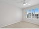 Bright bedroom featuring neutral carpet, ceiling fan, and shuttered window at 3665 S Jojoba Way, Chandler, AZ 85248