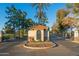 Elegant gated entrance to the community, featuring a charming guardhouse and mature trees at 3665 S Jojoba Way, Chandler, AZ 85248