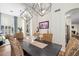 Open dining area with wicker chairs, dark table and views of living room with modern art at 3665 S Jojoba Way, Chandler, AZ 85248