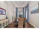 Elegant dining room with modern chandelier, dark wood table, and woven chairs at 3665 S Jojoba Way, Chandler, AZ 85248