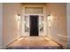 Close-up of front door with beautiful ironwork flanked by stylish sconces and neutral colored entryway at 3665 S Jojoba Way, Chandler, AZ 85248