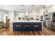 This kitchen features a large island with a white countertop, blue cabinets, and pendant lighting at 3665 S Jojoba Way, Chandler, AZ 85248