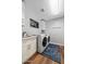 Bright laundry room with modern washer and dryer, a sink, and stylish blue rug at 3665 S Jojoba Way, Chandler, AZ 85248