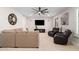Comfortable living room with a large TV and comfortable furniture arrangement and natural light at 3665 S Jojoba Way, Chandler, AZ 85248
