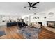 Open concept living space with a kitchen, fireplace, hardwood floors, and stylish furniture at 3665 S Jojoba Way, Chandler, AZ 85248