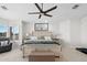 Well-lit bedroom with a king-sized bed, shuttered windows, and ceiling fan at 3665 S Jojoba Way, Chandler, AZ 85248