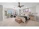 Bright bedroom with large windows, neutral decor, and a king-sized bed with decorative pillows at 3665 S Jojoba Way, Chandler, AZ 85248