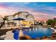 A luxurious backyard featuring a large swimming pool, patio seating, and a built-in bar area perfect for outdoor entertaining at 3665 S Jojoba Way, Chandler, AZ 85248