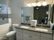 Bright bathroom with double sink vanity, stone countertop, and decorative mirror at 3677 E Park Ave, Gilbert, AZ 85234