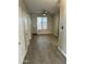 Hallway with wood-look flooring and natural light at 3677 E Park Ave, Gilbert, AZ 85234