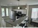 Bright kitchen with stainless steel appliances, granite countertops, a breakfast bar, and tile floors at 3677 E Park Ave, Gilbert, AZ 85234