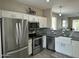 Well-equipped kitchen featuring stainless steel appliances, modern backsplash and white cabinets at 3677 E Park Ave, Gilbert, AZ 85234