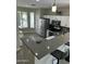 Bright kitchen with stainless steel appliances, granite countertops, a breakfast bar, and tile floors at 3677 E Park Ave, Gilbert, AZ 85234