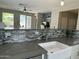 Bright kitchen with island seating open to the living room and backyard pool at 3677 E Park Ave, Gilbert, AZ 85234