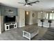 Open-concept living room with tile floors, neutral paint, and a ceiling fan at 3677 E Park Ave, Gilbert, AZ 85234