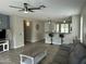 Open-concept living room with tile floors, neutral paint, and a view into the kitchen and breakfast bar at 3677 E Park Ave, Gilbert, AZ 85234