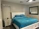 Cozy main bedroom with a plush blue comforter, white furniture, and a large mirror at 3677 E Park Ave, Gilbert, AZ 85234