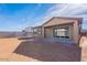Backyard with block wall, covered patio, and sliding glass doors for indoor/outdoor living at 39980 W Bunker Dr, Maricopa, AZ 85138