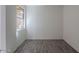 A view of the empty bedroom with wood-look floors and a window that lets in natural light at 39980 W Bunker Dr, Maricopa, AZ 85138