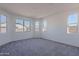 Bright bedroom featuring carpeting and large windows at 39980 W Bunker Dr, Maricopa, AZ 85138
