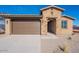 Inviting home featuring a two-car garage and stone facade at 39980 W Bunker Dr, Maricopa, AZ 85138
