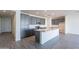 Modern kitchen with stainless appliances and gray cabinets at 39980 W Bunker Dr, Maricopa, AZ 85138