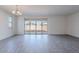 Bright living room with sliding glass doors to backyard at 39980 W Bunker Dr, Maricopa, AZ 85138