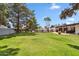 Lush backyard with green lawn, trees, and a refreshing swimming pool at 401 E Braeburn Dr, Phoenix, AZ 85022
