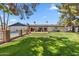 Well-maintained backyard featuring a swimming pool, privacy fence, and manicured lawn at 401 E Braeburn Dr, Phoenix, AZ 85022