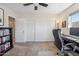 Bright bedroom featuring a ceiling fan, closet, and desk for a comfortable workspace at 401 E Braeburn Dr, Phoenix, AZ 85022