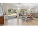 Open dining area featuring a modern chandelier, views to the lush backyard, and access to the covered patio at 401 E Braeburn Dr, Phoenix, AZ 85022