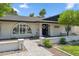 Charming home featuring a brick facade, arched window, and inviting walkway leading to a welcoming front door at 401 E Braeburn Dr, Phoenix, AZ 85022