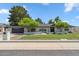 Charming single-story home with manicured lawn, mature trees, and a brick facade at 401 E Braeburn Dr, Phoenix, AZ 85022