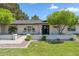 Beautiful home with a well-maintained lawn, brick accents, and mature trees enhancing the curb appeal at 401 E Braeburn Dr, Phoenix, AZ 85022
