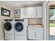 Functional laundry room equipped with modern washer and dryer and sink at 401 E Braeburn Dr, Phoenix, AZ 85022