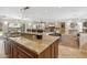 Gourmet kitchen with granite countertops open to a large living room with stone fireplace and backyard views at 401 E Braeburn Dr, Phoenix, AZ 85022