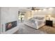 Light-filled main bedroom featuring a fireplace, ceiling fan, and access to the covered back patio at 401 E Braeburn Dr, Phoenix, AZ 85022
