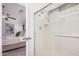 Bright bathroom with a glass-door shower, neutral tones, and access to the main bedroom at 40329 W Thornberry Ln, Maricopa, AZ 85138