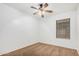 Minimalist bedroom with carpeted floors, a ceiling fan, and a window with blinds at 40329 W Thornberry Ln, Maricopa, AZ 85138
