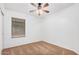 Bright bedroom features plush carpet, ceiling fan, and a large window with horizontal blinds at 40329 W Thornberry Ln, Maricopa, AZ 85138