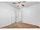 Minimalist bedroom with carpeted floors, a ceiling fan, access to a closet and an ensuite bathroom at 40329 W Thornberry Ln, Maricopa, AZ 85138