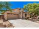 Quaint, single-level home with two-car garage, a welcoming entrance, and attractive desert landscaping at 40329 W Thornberry Ln, Maricopa, AZ 85138