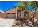 Charming single-story home featuring desert landscaping, a two-car garage, and a welcoming front entrance at 40329 W Thornberry Ln, Maricopa, AZ 85138