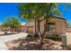 View of home featuring desert landscaping and a driveway leading to an attached two-car garage at 40329 W Thornberry Ln, Maricopa, AZ 85138
