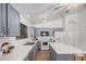 Bright kitchen with gray cabinets, an island with a marble countertop, and stainless steel appliances at 40329 W Thornberry Ln, Maricopa, AZ 85138