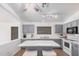 Kitchen with gray cabinets, granite countertop, island with stools, and stainless-steel appliances at 40329 W Thornberry Ln, Maricopa, AZ 85138