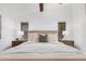 Comfortable main bedroom with neutral tones, a ceiling fan, carpeted floors, and two bedside tables at 40329 W Thornberry Ln, Maricopa, AZ 85138